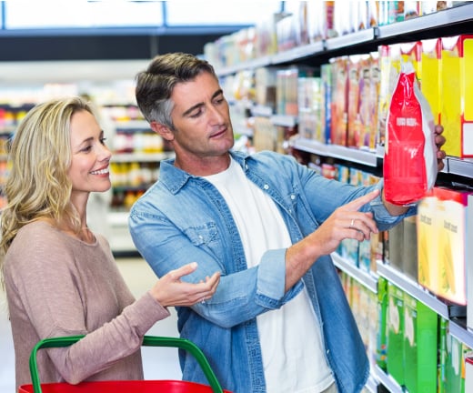 supermarket shopping - couple looking at package