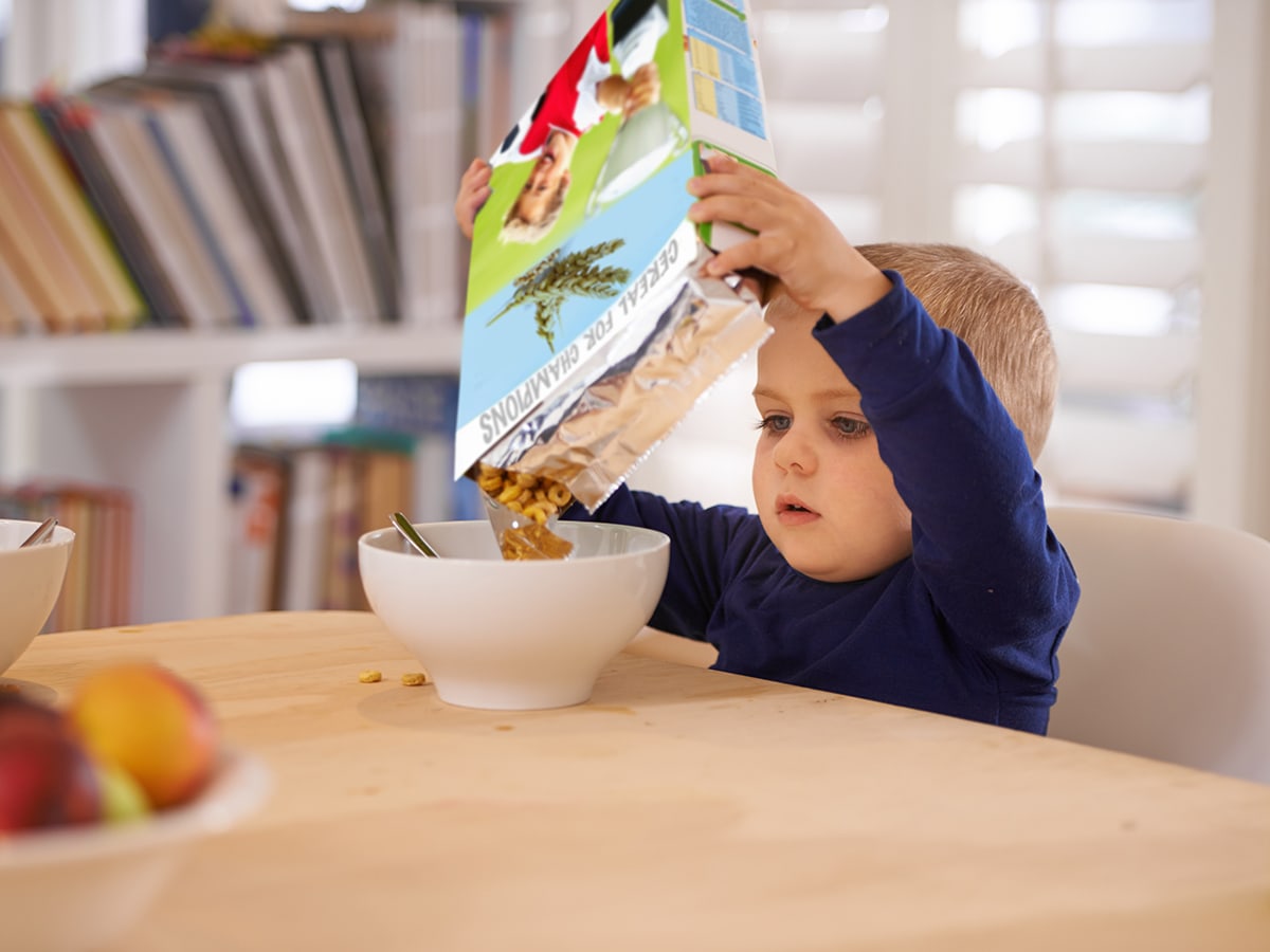 child pouring cereal out of a non resealable container